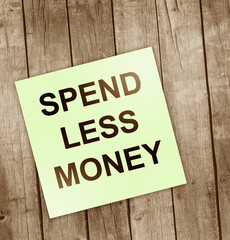 Spend less money words written on white paper pieces with background. Business finance concept. Conceptual image
