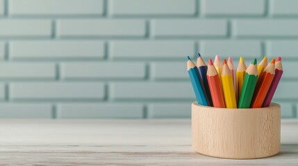 Fototapeta premium A collection of colorful pencils arranged in a wooden holder against a light blue brick wall, showcasing creativity and artistic tools.