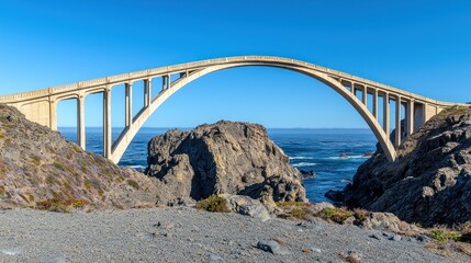 A stunning arch bridge spanning rocky coastal terrain and ocean.