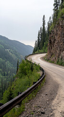 Dramatic curve on a mountain highway with moody overcast sky