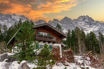 mountain hut in the mountains at the Zugspitze in the Alps with sunset