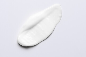 A sample of a white moisturizing cosmetic cream for the body or face