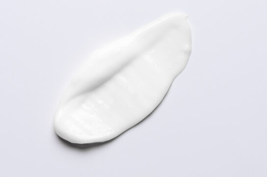 A sample of a white moisturizing cosmetic cream for the body or face