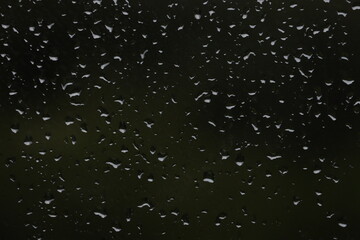 Abstract background of drops on a window close-up.