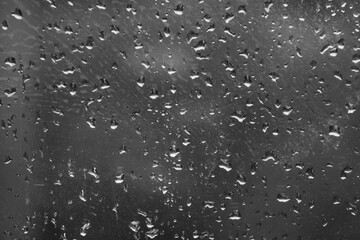 Abstract background of drops on a window close-up.