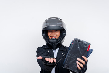 A friendly young Asian woman delivery rider holding a small parcel while requesting payment, possibly cash on delivery. Isolated on a white background.