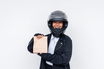 Motorcycle delivery person holding takeout bag while smiling, wearing black jacket and helmet