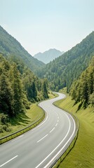 Fototapeta premium A winding road cuts through a lush green forest with rolling hills and distant mountains under a clear blue sky.