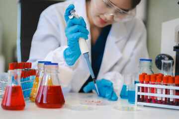 Female biotechnologist testing new chemical substances in a laboratory.