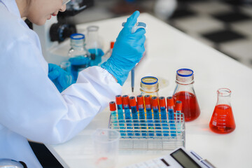 Female biotechnologist testing new chemical substances in a laboratory.