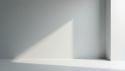 A minimalist studio room with a light gray backdrop and soft light creates a tranquil setting.