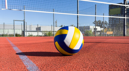 volleyball. blue with yellow color ball on the playground. volleyball cover, red. ball game
