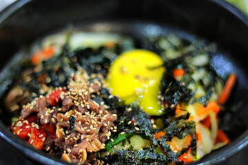 Close-Up of Traditional Bibimbap with Fresh Ingredients in a Bowl
