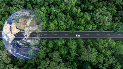 Aerial view EV electric vehicle car on middle green tree forest road globe earth planet, EV car electric vehicle car alternative sustainable energy eco power, Green business ecosystem environment.