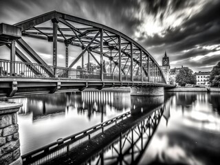 Stark black and white captures Turku's steel bridge, a Finnish river landscape's dramatic beauty.