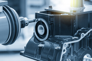 Closeup scene the milling spindle attached on the robotic arm finish cut the aluminum gear case.