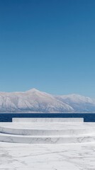 A serene white marble podium stands against an expansive ocean and vibrant blue sky, with distant mountains completing the tranquil scene.