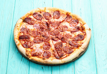 Pizza pepperoni fast food . Top view on rustic background