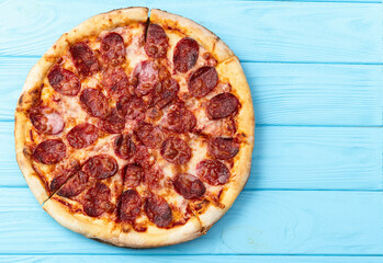 Pizza pepperoni fast food . Top view on rustic background