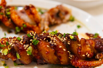spicy grilled octopus skewers on the dish