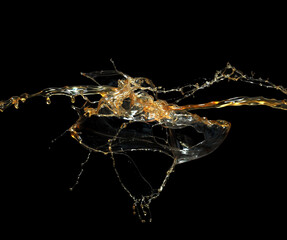 Liquid caramel splashes on black background