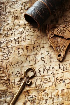 Ancient script, key, artifact, aged scroll, leather tube.