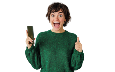 Excited woman in a green sweater holding a smartphone vertically and pointing, set against a plain white background.

