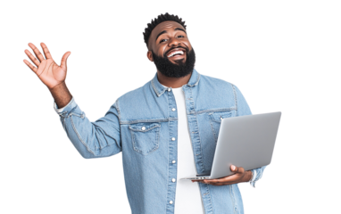 Happy man in a denim shirt holding a laptop in one hand and waving with the other, displaying a cheerful expression, set against a plain white background.

