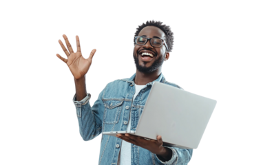 Happy man in a denim shirt holding a laptop in one hand and waving with the other, displaying a cheerful expression, set against a plain white background.

