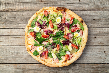 Italian pizza caesar with eggs salad chicken tomatoes and mozzarella photography. top view