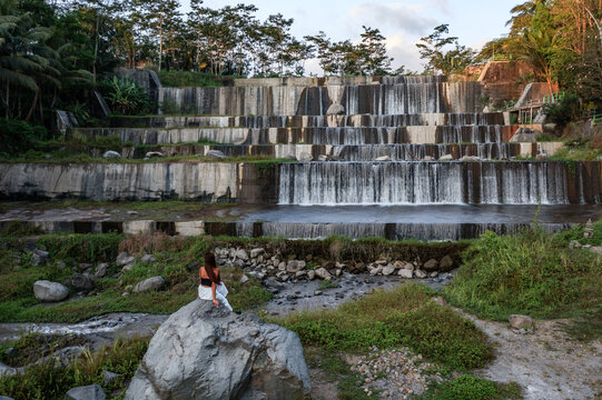 Woman looking at artificial waterfall, Yogyakarta, Java, Indonesia