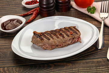 Grilled beef striploin steak with sauce
