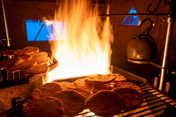 Pita Bread Cooking on fire inside a Kota Cabin in Lapland Finland
