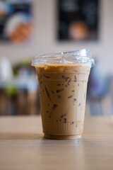 Iced esspesso coffee in take away glsss on wood table