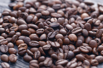 Coffee beans on the dark wooden background