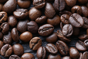 Coffee beans on the dark wooden background