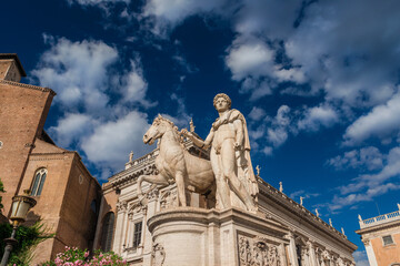 Obraz premium Capitoline Hill with ancient roman statues, medieval church and renaissance palace with clouds, in the very center of Rome