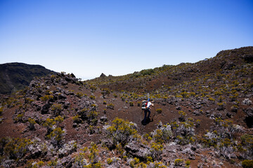 Man climbing a rock in Volcanic Terrain Reunion Island