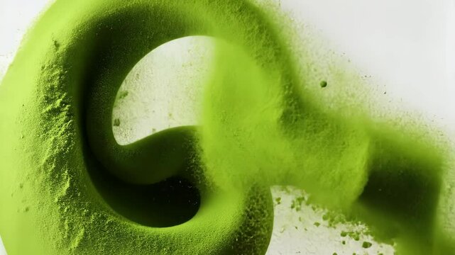 Green object with a spiral shape is shown in the air. The object is green and he is a piece of food. The image has a playful and whimsical mood, as the object seems to be floating in the air