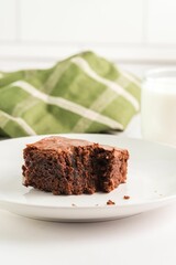 Chocolate brownie with milk and napkin.