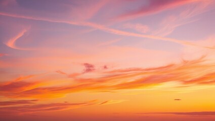 Fototapeta premium The beauty of luxurious soft gradient clouds in shades of orange and gold, with sunlight glowing against the blue sky, creates a perfect evening twilight backdrop.