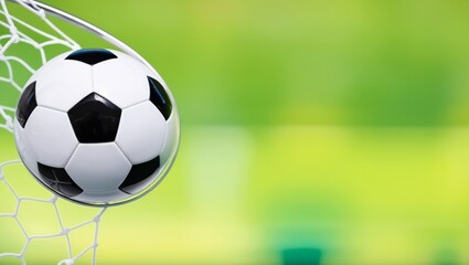 Sunlight shining on a soccer ball in the goal.