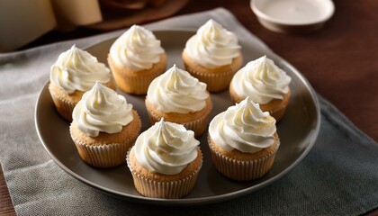 Delicious mini cupcakes with white creamy frosting