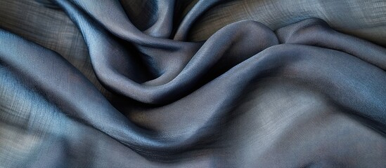 Fototapeta premium Elegant Dark Grey Silk Fabric Folds Textured Background with Ample Copyspace for Creative Design and Visual Projects