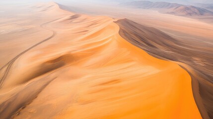 Aerial view of vast desert landscape with winding sand dunes creating natural patterns and ample space for text or branding integration