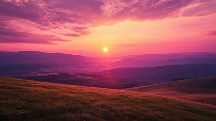 Breathtaking sunrise over rolling hills with vibrant pink and orange hues illuminating the landscape and tranquil horizon view.