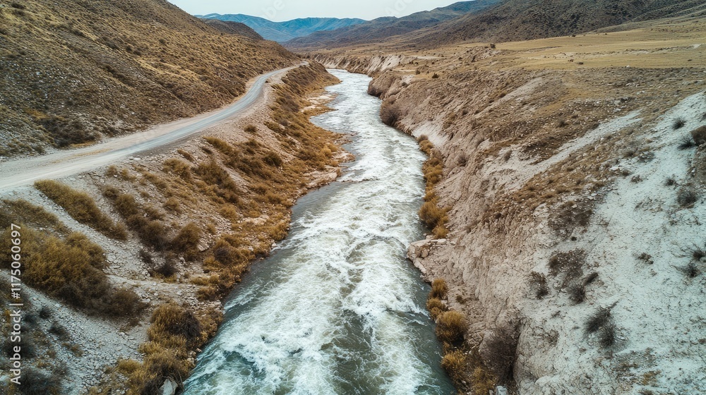 Poster aerial view of a winding river flowing through a rugged desert landscape alongside an empty mountain