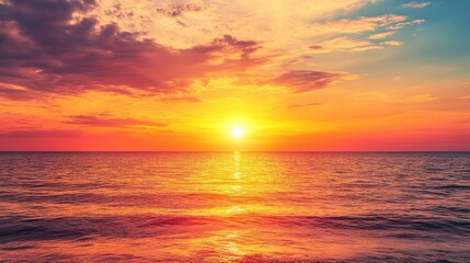 Fototapeta premium Stunning golden sunset over the serene sea with vibrant clouds reflecting the warm hues of nature's beautiful transitional light.