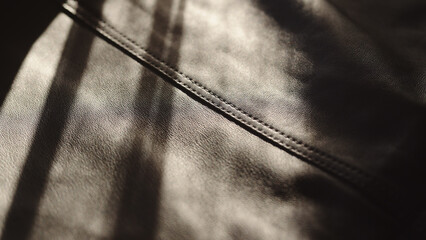 soft supple gray leather background with light streak from sun