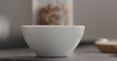 white bowl with granola on terrazzo countertop